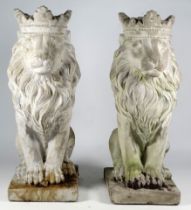 A pair of reconstituted stone lions - seated with coronets, height 35cm.