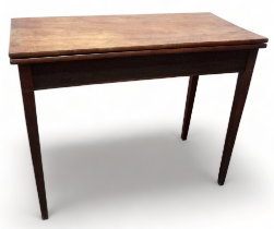 A late George III mahogany tea table - the rectangular top above a gateleg action, on tapered square