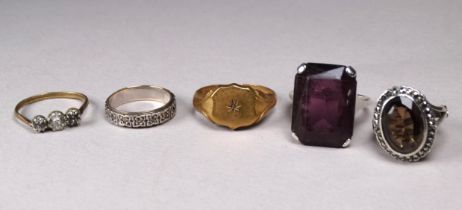 A small collection of rolled gold and silver rings.