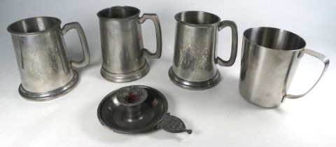 A pewter chamberstick - together with three pewter tankards and a steel tankard. (5)