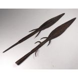 Two 19th century spear heads - with barbs, one fitted with a socket, the other with a spike,