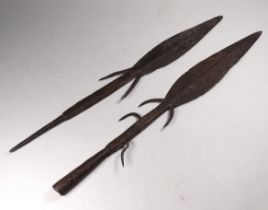 Two 19th century spear heads - with barbs, one fitted with a socket, the other with a spike,