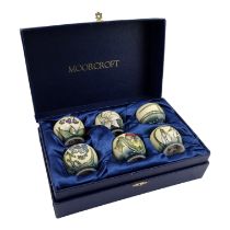 A boxed set of six Moorcroft Pottery eggcups - tubeline decorated with flowers, comprising 'Snakes