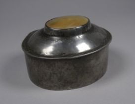 A pewter box by Liberty - of oval planished form, the hinged lid set with mother of pearl, width