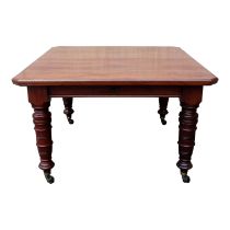 A late Victorian mahogany extending dining table - the square top with canted corners above a