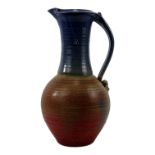 A large St Agnes Pottery jug - with elongated blue glazed neck decorated with paterae to spout,
