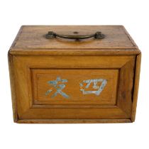 A late 19th century mahjong set - in a camphor wood box, the tiles of bone and bamboo, width 23cm.