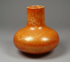 A Ruskin Pottery vase - orange glazed, with narrow tapering neck, stamped to base, height 10cm.