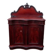 A Victorian mahogany credenza - the raised shaped back carved with fruit and flowers above a