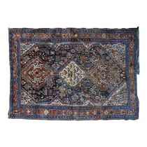 A Senneh style rug - with a cream central medallion featuring birds, on a dark blue ground, 196 x