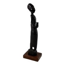 A carved hardwood African figure - holding a box, height 38cm.