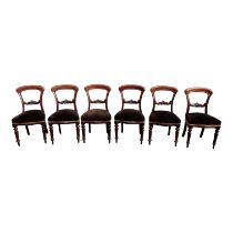 A set of six Victorian mahogany balloon back dining chairs - with upholstered seats on turned