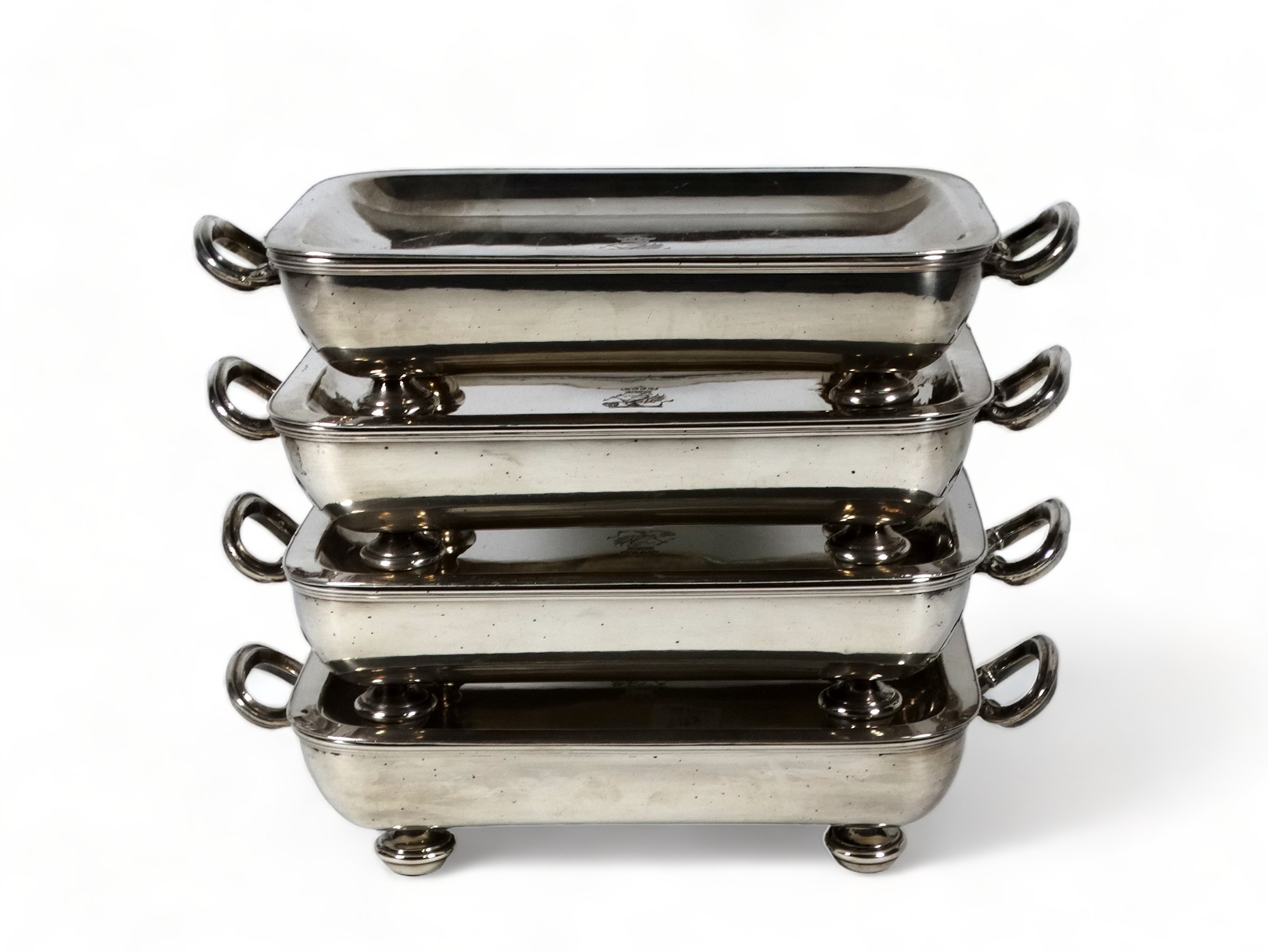 A set of four silver plated rectangular food warmers - dish shaped and engraved with armorial,