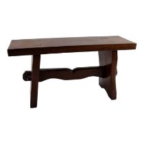 A small hardwood low seat stool - the rectangular top with wedged mortice joints and shaped end