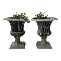 A pair of lead garden urns - of fluted campana form, raised on square bases, height 49cm. (2)