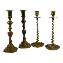 A pair of late 19th century brass candlesticks - of baluster form with canted square bases, height