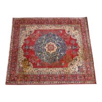 A Persian rug - with a garden design on a red ground within a blue border, 294 x 248cm