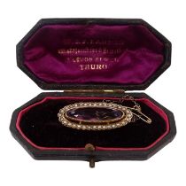 A Victorian seed pearl and amethyst brooch - of broad oval form, 4.5g cased.