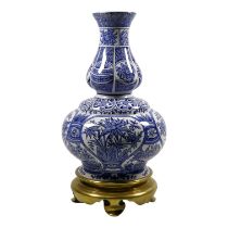 A late 19th century English blue and white lamp base - of double gourd form decorated with flowers