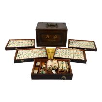 A 20th century mahjong set - circa 1923, in a hardwood box with brass mounts, the tiles of bone