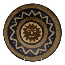 Menorca Pottery - a pottery dish, decorated with a sun motif within a zig-zag border, diameter 28cm.