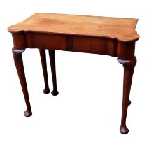 A George III and later mahogany games table - the rectangular top with rounded corners opening to