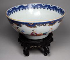 A 19th century Chinese bowl - decorated with vignettes showing figures in a garden, diameter 23cm,