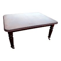 A Victorian mahogany extending dining table - the rectangular moulded top with leaf insertions above