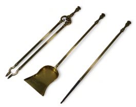 A set of three 19th century brass fire irons - comprising poker, tongs and shovel.