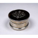 A silver pill box - Birmingham 1917, circular with a tortoiseshell top inset with birds and foliage,