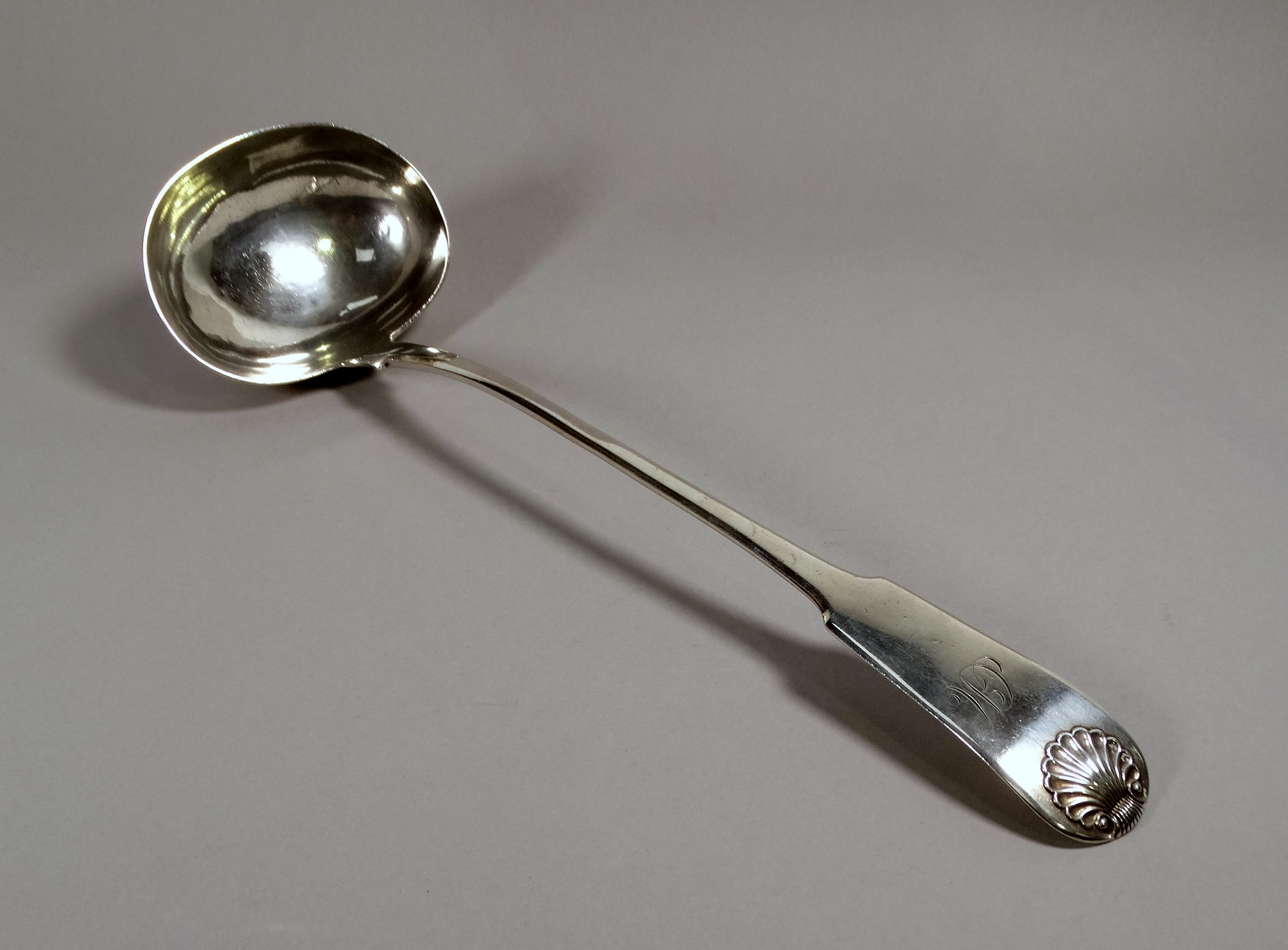 A large silver ladle - Edinburgh 1820, Andrew Wilkie, fiddle back with scallop shell and engraved