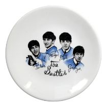 A mid 20th century Beatles plate - images of 'The Fab Four' wearing blue jackets, diameter 18cm.