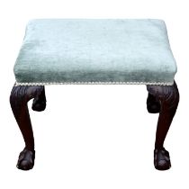 A George III and later reconstructed mahogany stool - the rectangular green upholstered seat on leaf