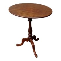 A 19th century mahogany wine table - the oval top above a turned support and tripod base, 58 x 44