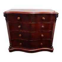 A Victorian mahogany chest of drawers - of serpentine form, the moulded top above an arrangement