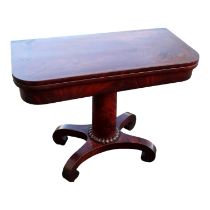 An early Victorian mahogany card table - the rectangular fold-over top above a turned support and