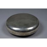 A silver tobacco box - London 1927, Goldsmiths & Silversmiths, of circular form with a gilded