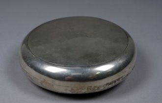 A silver tobacco box - London 1927, Goldsmiths & Silversmiths, of circular form with a gilded