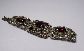 An Austro-Hungarian style bracelet - in three pierced foliate sections set with purple and white