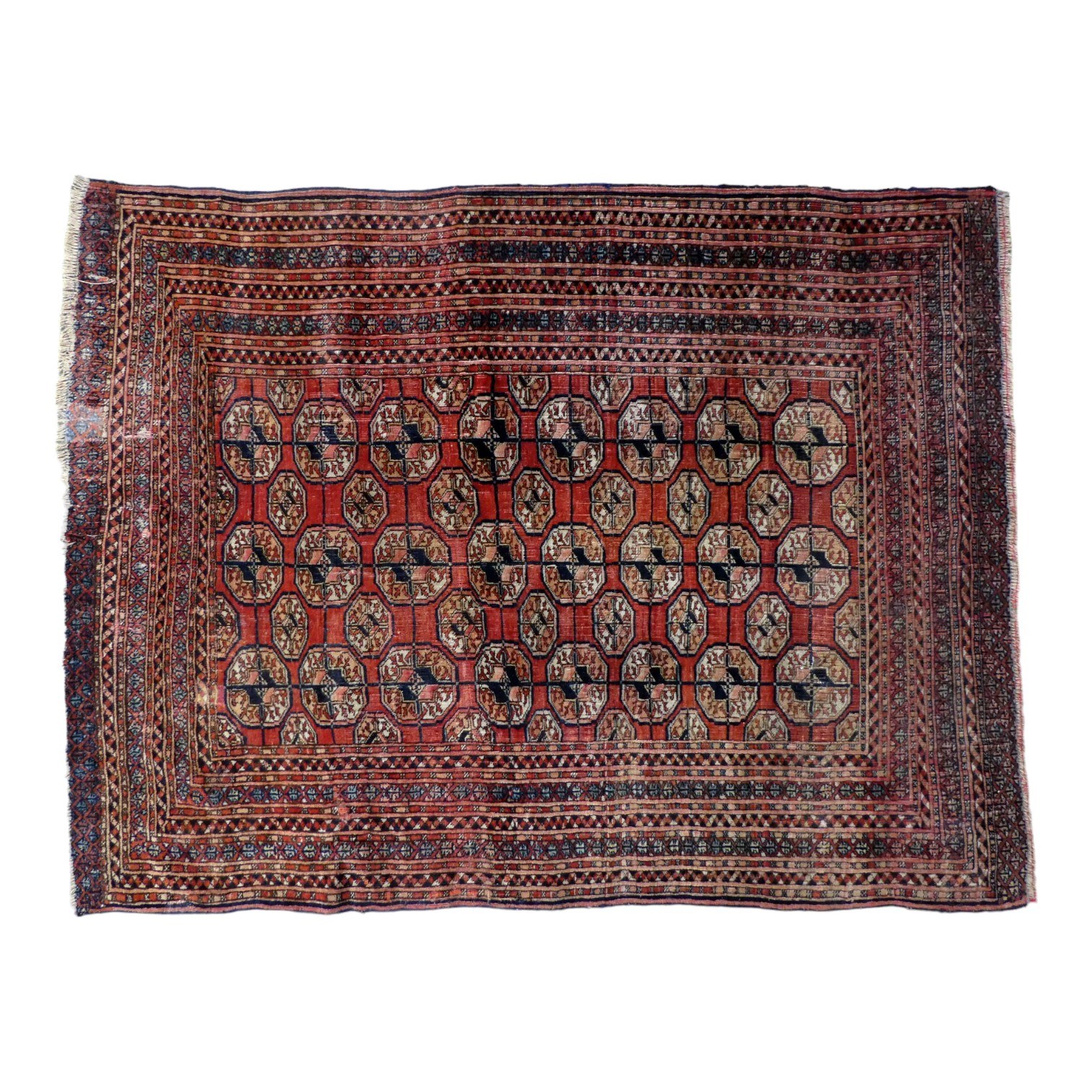 A Bokhara rug - decorated with an arrangement of gul motifs on a red ground, the border with