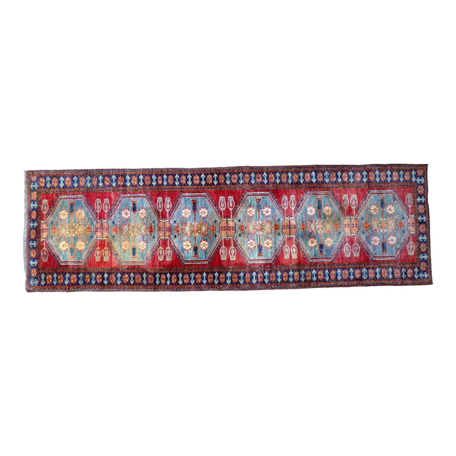 A Bokhara runner - with six light blue medallions on a red ground within a blue border, 286cm x