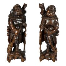 A pair of early 20th century Chinese carved hardwood figures - in the form of immortals, height