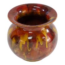 A Linthorpe Pottery vase - of red and yellow trickle glazes, numbered and marked to base, height