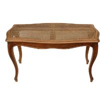 A Louis XVI style walnut window seat - with a rectangular cane upholstered seat, on carved