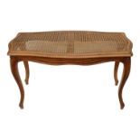 A Louis XVI style walnut window seat - with a rectangular cane upholstered seat, on carved