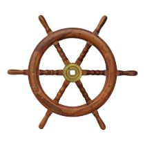 A mahogany ship's wheel - with six turned spokes and a brass hub, diameter 70cm.