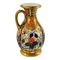 A Royal Worcester Imari decorated jug - the floral panels incorporating birds, height 16cm.