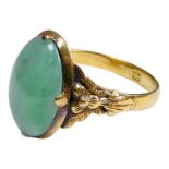 A cabochon jade ring - set in high purity yellow metal with foliate shoulders, weight 3.5g.