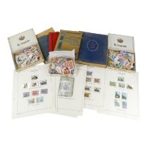 Four albums of various world stamps - together with a quantity of used world stamps and a