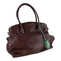 A Coccinelle brown leather hand bag - with chrome fittings, together with a dust bag.